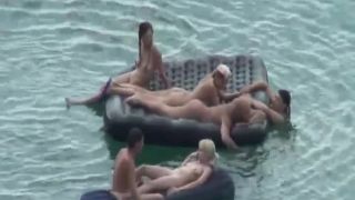 Nude people floating on air mattresses  720-0