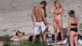 Sexy blonde in polka dot bikini chills with friends on  beach-7