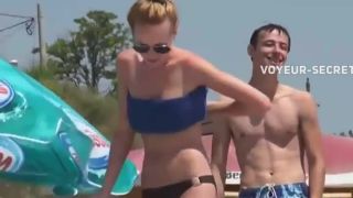 Topless babe smoking on a beach Voyeur!-0