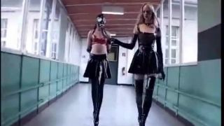 Latex Mistresses. Two latex Mistresses train their latex female slaves with crops and pony training-0