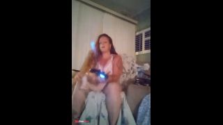 Innocent girl with long brunette wavy hair filming herself in her pink nightgown playing video games-9