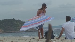 Topless milf gives back rub on beach-0